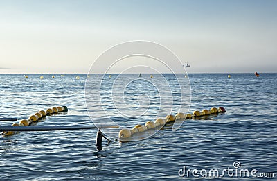 Handrails on beach for disabled people with ship at bottom in th Stock Photo