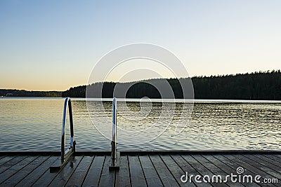 Handrails on the wooden swimming pier and The Lake Saimaa onthe background, Ukonlinna beach, Imatra, Finland Stock Photo