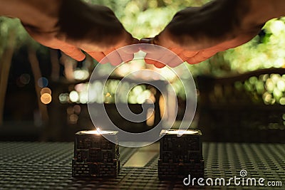 Hands above candles for Shabbat meal Stock Photo