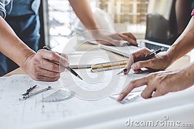 Hands of architect or engineer working on blueprint meeting for project working with partner on model building and engineering Stock Photo