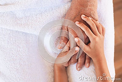 Hands of asian child girl holding elderly grandparent hands wrinkled skin Stock Photo