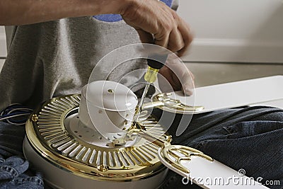 Hands assembling a Ceiling Fan Stock Photo