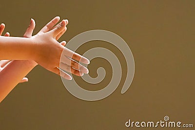 The hands of the audience clapping and cheering. Stock Photo