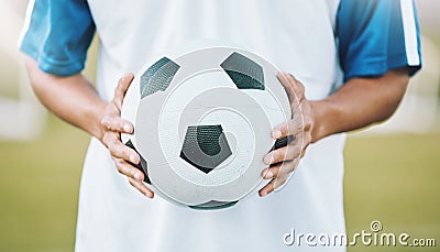 Hands, ball and soccer player ready for sports match, game or competition on the outdoor field. Hand holding round Stock Photo