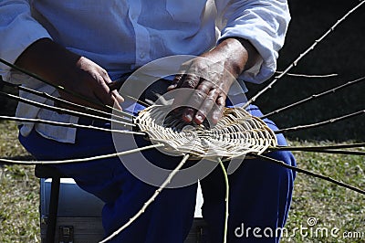 Hands of basket-maker working Stock Photo