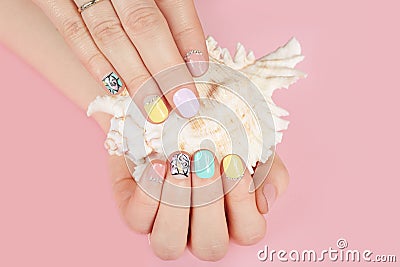 Hands with beautiful manicured nails and sea shell Stock Photo