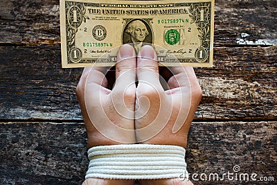 Hands bound men and money in the hands a symbol of slavery Stock Photo