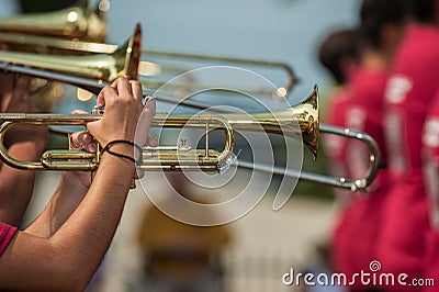 Hands on the brass while marching. Stock Photo