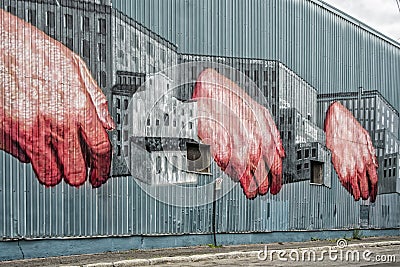 Hands on a building wall Editorial Stock Photo