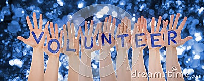 Hands Building Word Volunteer, Glittering And Sparkling Bokeh Background Stock Photo