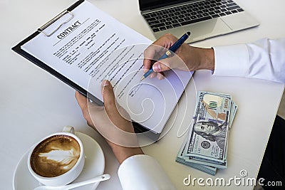 Hands of business man signing the contract document with pen on desk Stock Photo