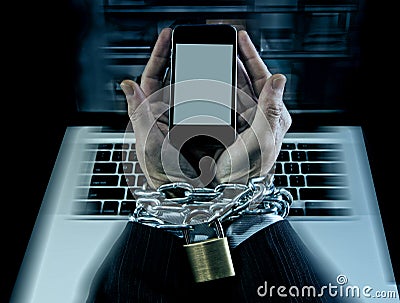 Hands of businessman addicted to work locked and enchained in mobile phone addiction Stock Photo