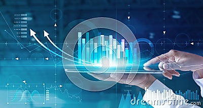 Hands of businessman analyzing sales data and economic growth graph chart on tablet and hologram screen. Stock Photo