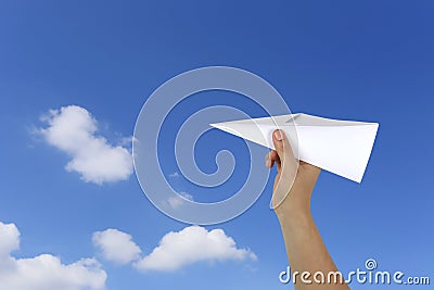 Hands of businessman catch a paper plane on blue sky background. Stock Photo