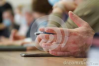 Hands of a businessman politician or lawyer on the table next to a pen and a smartphone. Official, boss or deputy. Participation Stock Photo