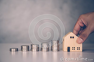 Hands of businessman and stack of coin with saving money for real estate and success, finance and investment. Stock Photo