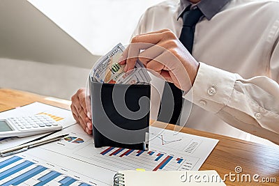 The hands of businessmen carrying dollars and wallets in order to save money, grow a successful business and save for retirement Stock Photo