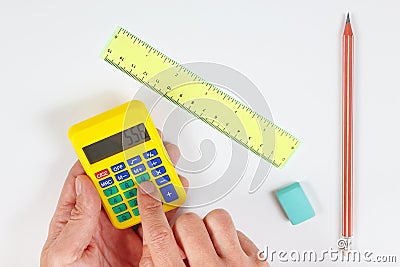 Hands calculate using a calculator over workplace of the engineer Stock Photo