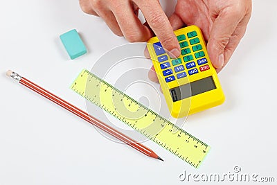 Hands calculate using a digital calculator over workplace of the engineer Stock Photo