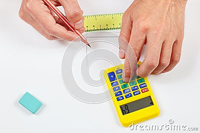 Hands calculate using a pocket calculator over workplace of the engineer Stock Photo