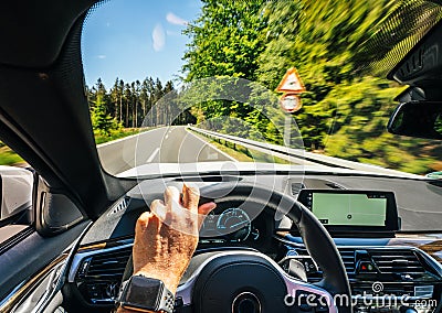 Hands of car driver on steering wheel, road trip, driving on highway road Stock Photo