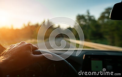 Hands of car driver on steering wheel, road trip Stock Photo