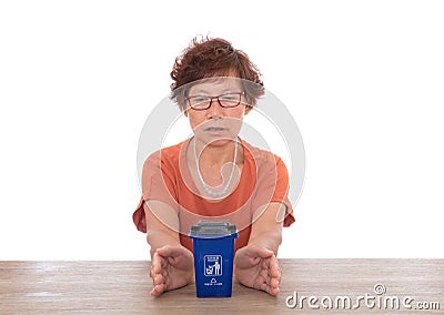 Hands care of the blue recyclable garbage trash can model.The Chinese characters on the trash can mean`Recyclable garbage` and`Eve Stock Photo