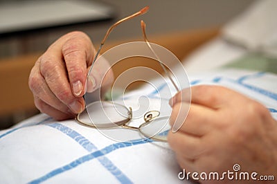 Hands of a care-dependent person holding glasses Stock Photo