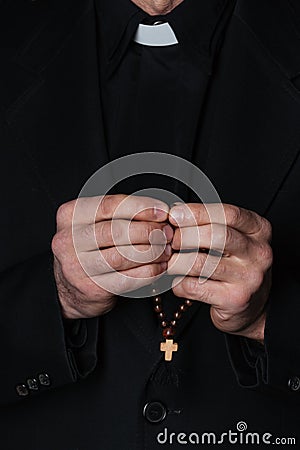 Hands of catholic priest holding rosary Stock Photo