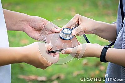 Hands checking wallet with stethoscope,take care,support and be concerned about of money problems,financial health care,money Stock Photo