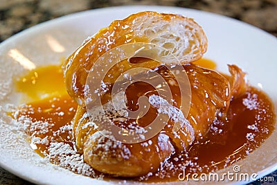 Croissant Caramel Almond Slice Sweet Delicious the hands of the chef in gloves cut a delicious dessert soft airy porous Stock Photo