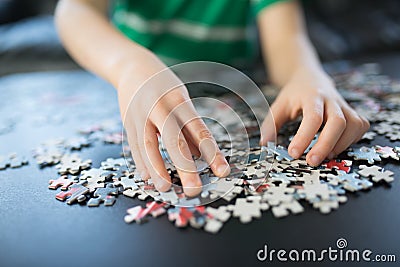 Hands of a child doing a puzzle Stock Photo