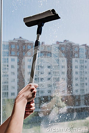 Hands of child hold cleaning products for window cleaner Stock Photo