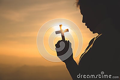 Hands of a Christian Women holding a cross while praying to God, Religious beliefs, Copy space Stock Photo