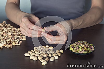 Hands clean pistachios nuts.The manual labor concept. Stock Photo