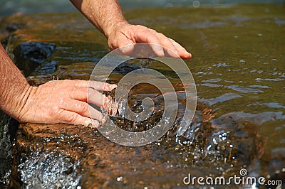 Hands in Clean Running Water of Stream Stock Photo