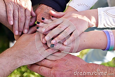 Hands close-up of people of various ages symbolising the concept of family, love and different generations working together. Stock Photo