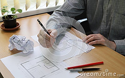 Hands close-up. Person makes notes in the architectural floor plan Stock Photo