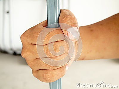 Hands clutching bars Stock Photo