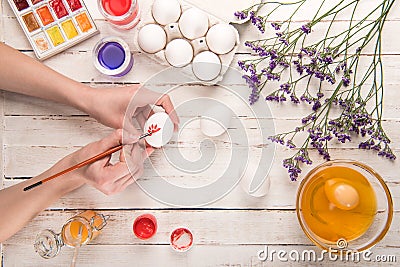 Hands coloring egg Stock Photo