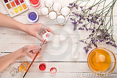 Hands coloring egg Stock Photo