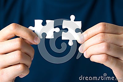 Hands connecting jigsaw puzzle. Stock Photo