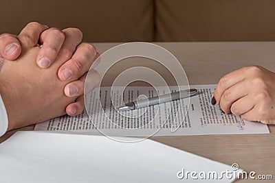 Hands of contractual parties, a woman and a man, signing a contract Stock Photo