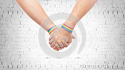 Hands of couple with gay pride rainbow wristbands Stock Photo