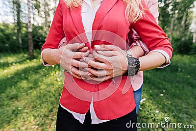 Hands of a couple in love. Man and woman are standing embracing. Stock Photo