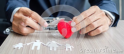 Hands cover Family paper and red heart. Healthcare and Insurance concept Stock Photo