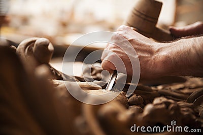 Hands of craftsman carve with a gouge Stock Photo