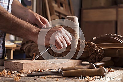 Hands of craftsman carve with a gouge Stock Photo