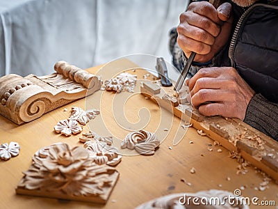 The hands of a craftsman carve wooden decorations Stock Photo