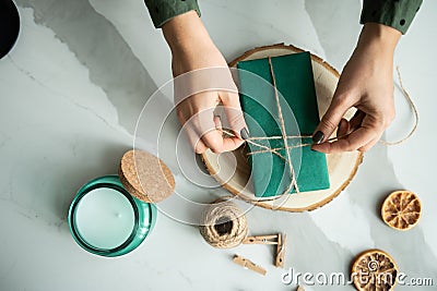 Hands creating Christmas decorations from recycled materials Stock Photo